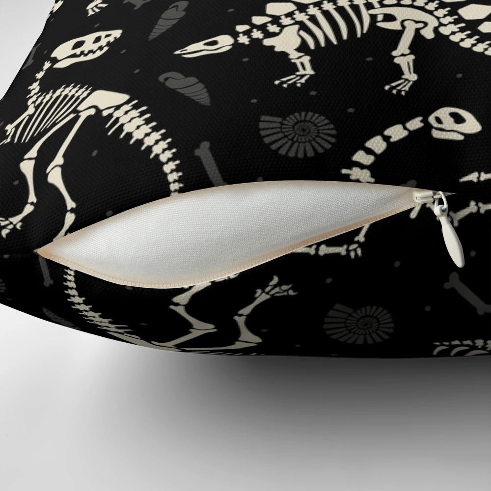Black and white pillow with a dinosaur fossil design