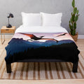 Plush blanket featuring a prehistoric flying reptile soaring over a mountain landscape