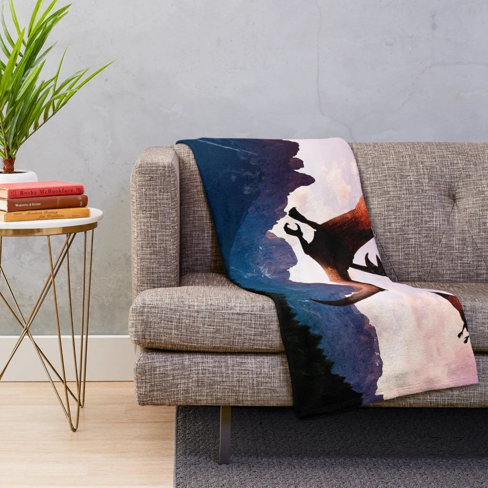 Plush blanket featuring a prehistoric flying reptile soaring over a mountain landscape