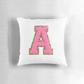A pink pillow with a preppy letter design, perfect for a stoney clover lane inspired room.