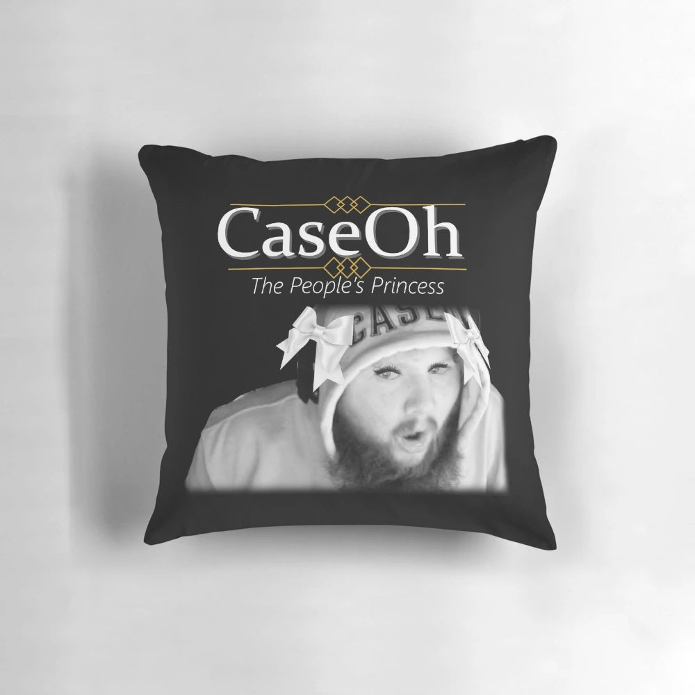A black and white image of a pillow featuring a parody design of Princess Diana.