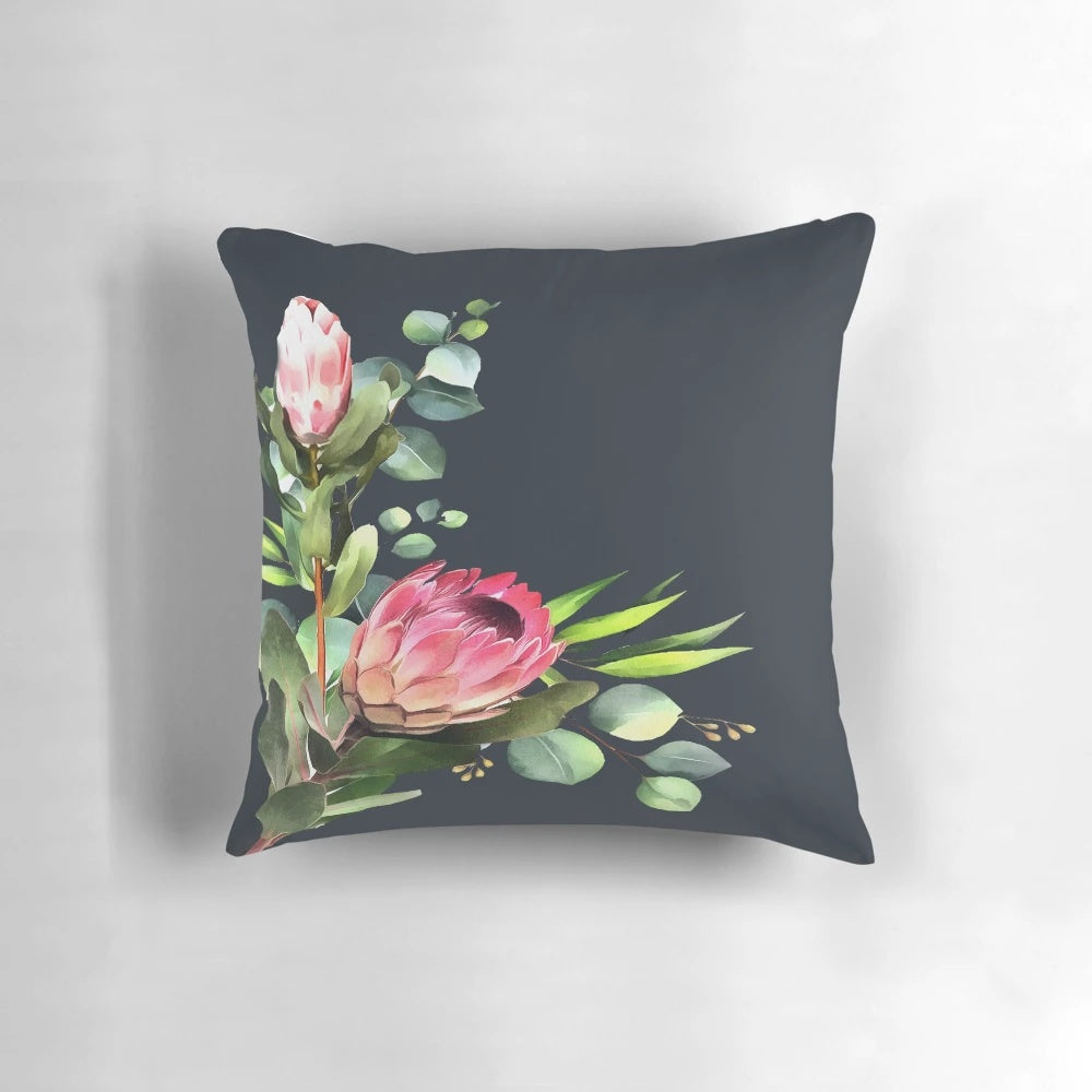 Closeup of a blue and pink protea flower print on a decorative pillow