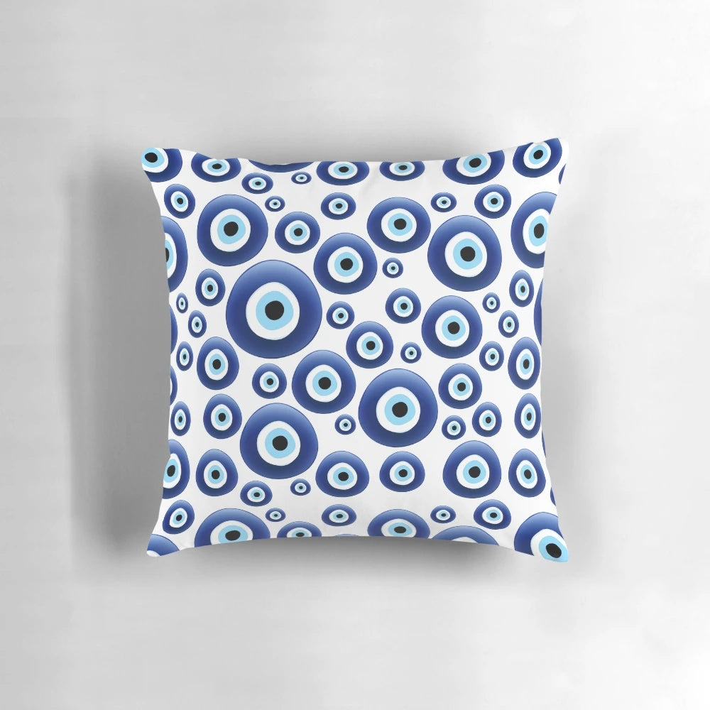 A blue and white patterned pillow with the traditional Mediterranean evil eye design