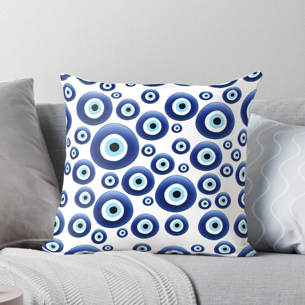 A blue and white patterned pillow with the traditional Mediterranean evil eye design