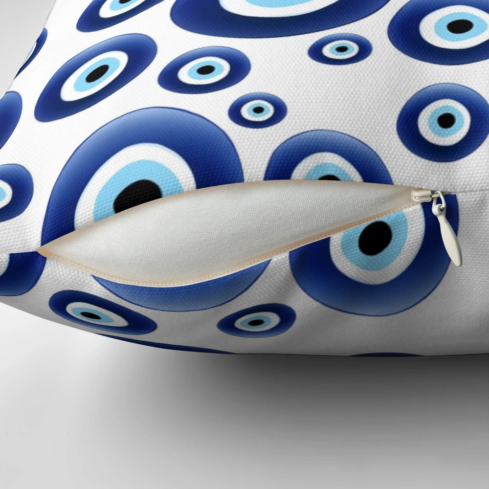 A blue and white patterned pillow with the traditional Mediterranean evil eye design