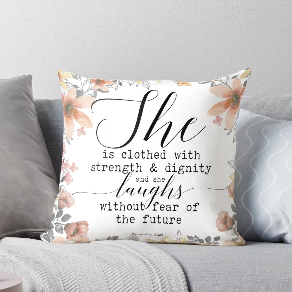 Proverbs 31:25 inspirational pillow with "She is clothed with strength and dignity, and she laughs without fear of the future" bible verse