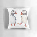 Illustration of puffins dancing and tapping on a decorative pillow