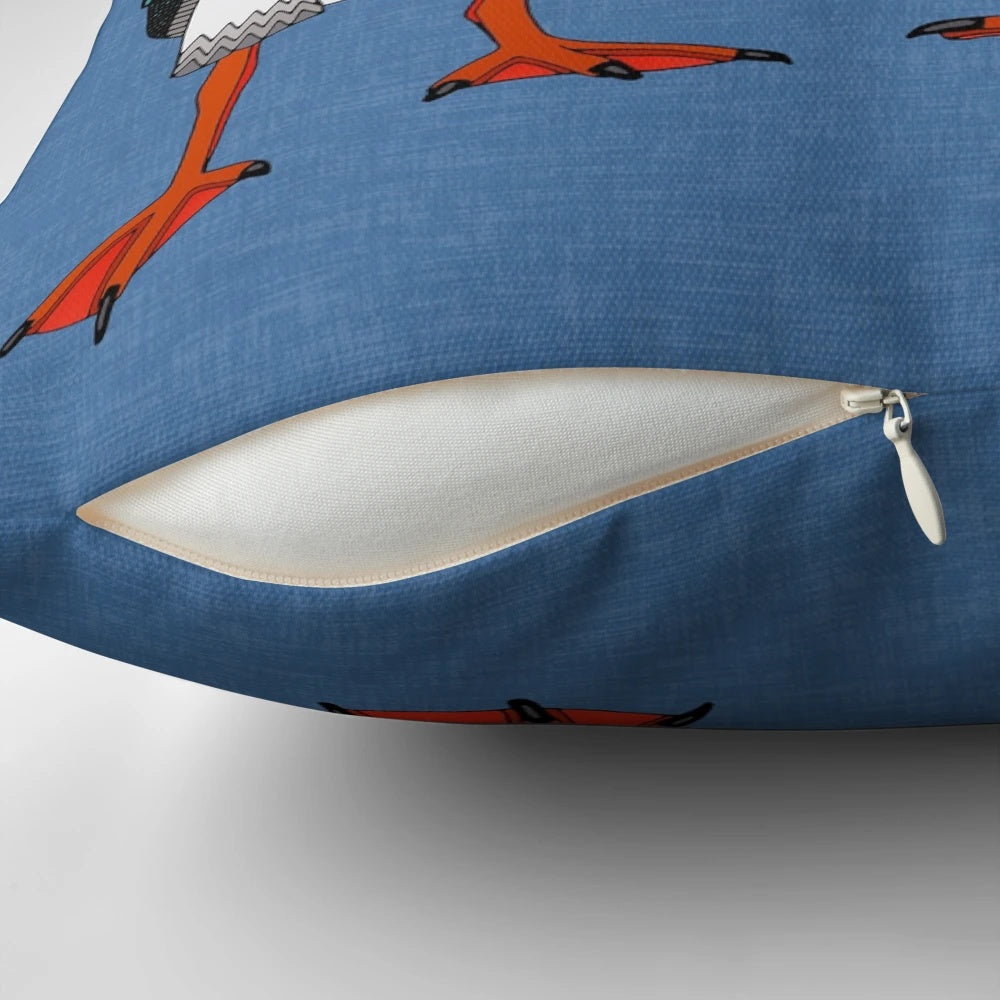 A pair of puffins in shades of blue on a decorative linen pillow.