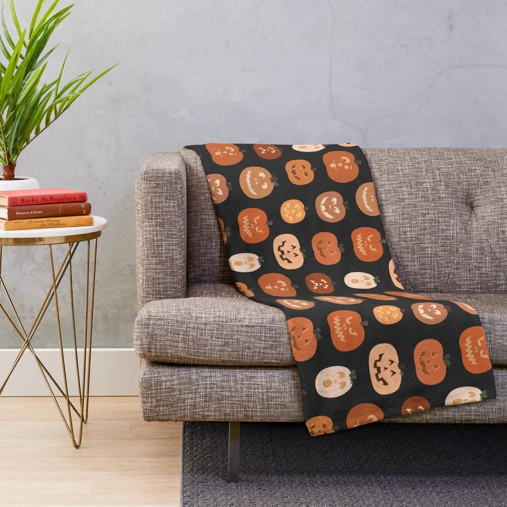 Pumpkin-patterned plush blanket with jack o'lanterns