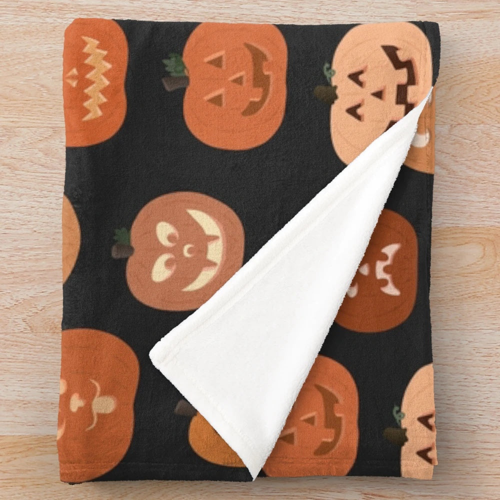 Pumpkin-patterned plush blanket with jack o'lanterns