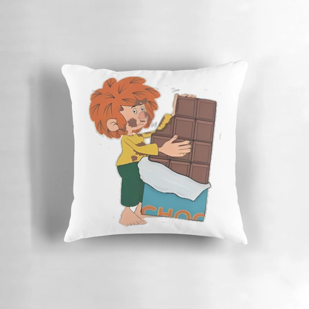 Pumuckl, the red-haired kobold from the popular German children's series, enjoying a piece of chocolate on a cozy pillow.