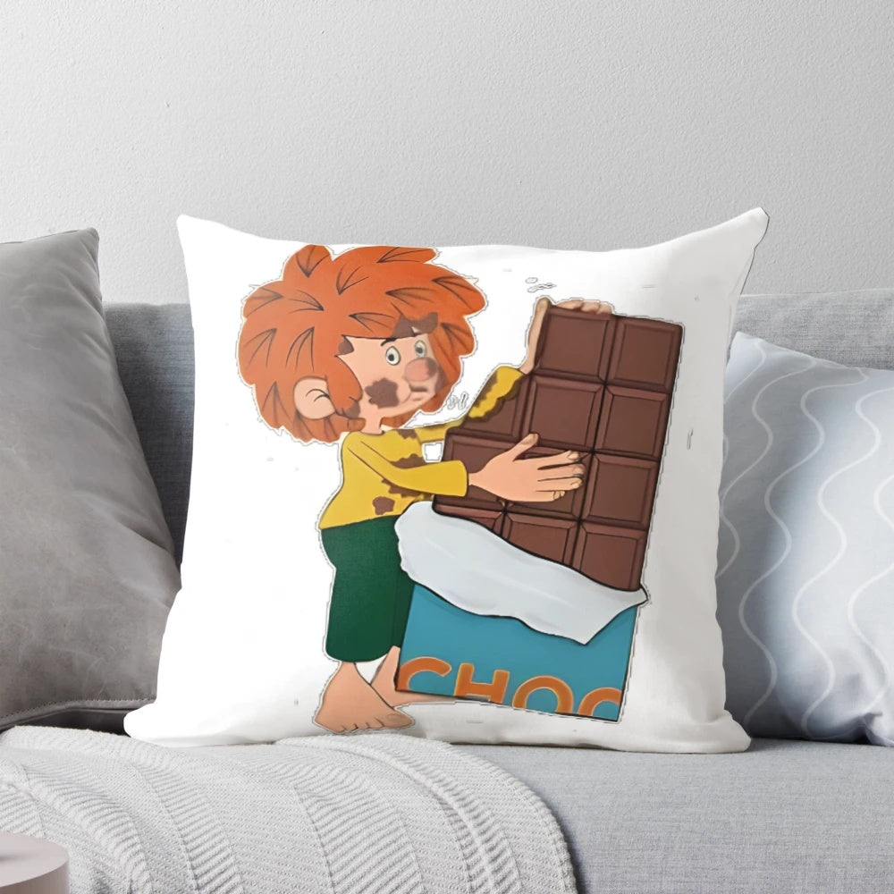 Pumuckl, the red-haired kobold from the popular German children's series, enjoying a piece of chocolate on a cozy pillow.