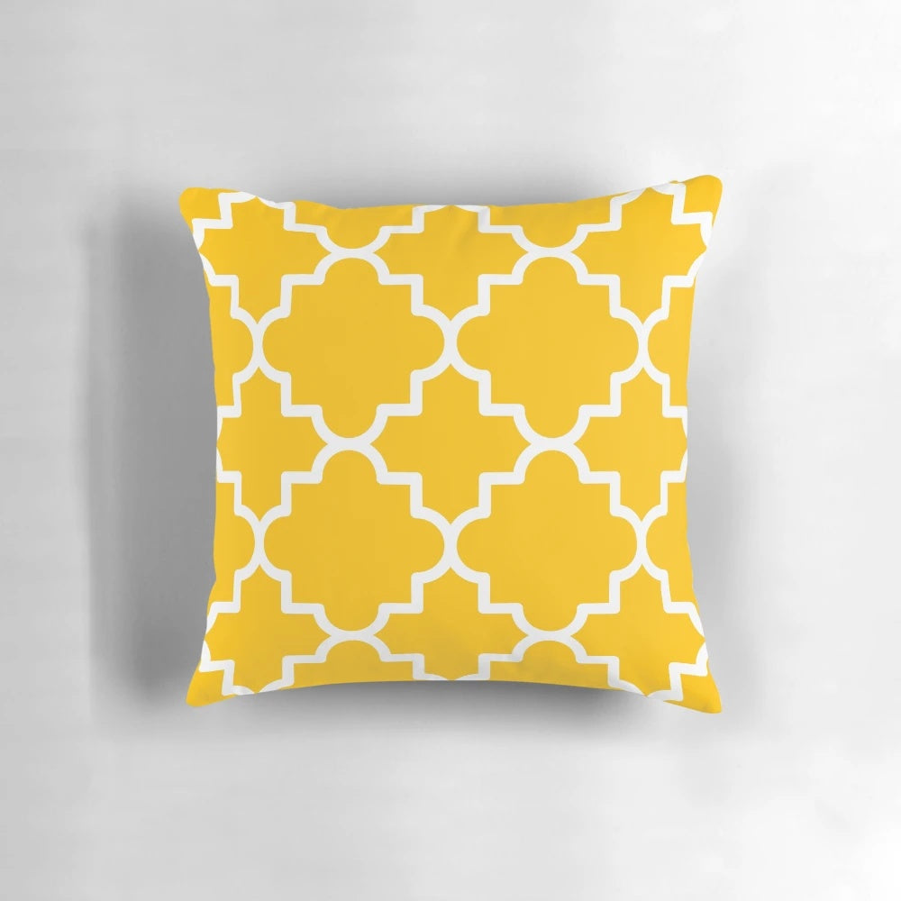Quatrefoil-patterned pillow in a bold yellow and white color scheme, creating a visually striking and Moroccan-inspired home accent.