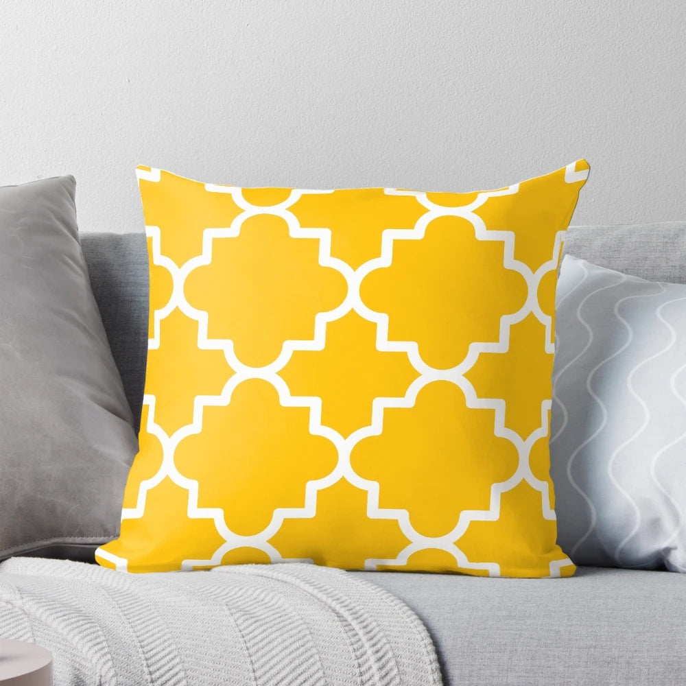 Quatrefoil-patterned pillow in a bold yellow and white color scheme, creating a visually striking and Moroccan-inspired home accent.