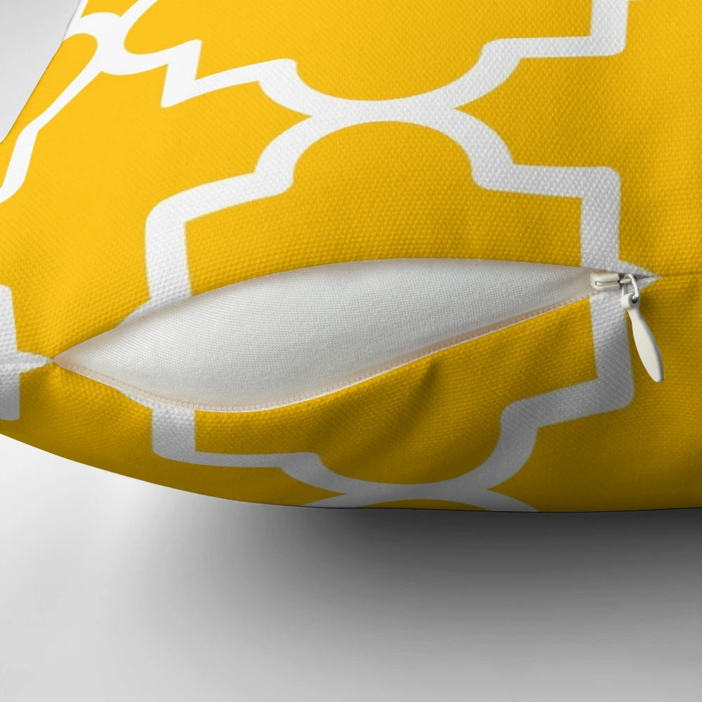 Quatrefoil-patterned pillow in a bold yellow and white color scheme, creating a visually striking and Moroccan-inspired home accent.