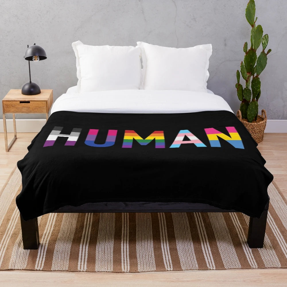 Colorful plush blanket featuring various LGBTQIA+ pride flags