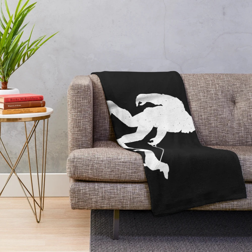 Bigfoot walking a dachshund wiener dog on a plush blanket