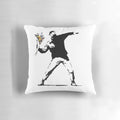 Throw pillow featuring a stencil design of a person throwing a flower, inspired by the Banksy "Flower Bomber" street art.