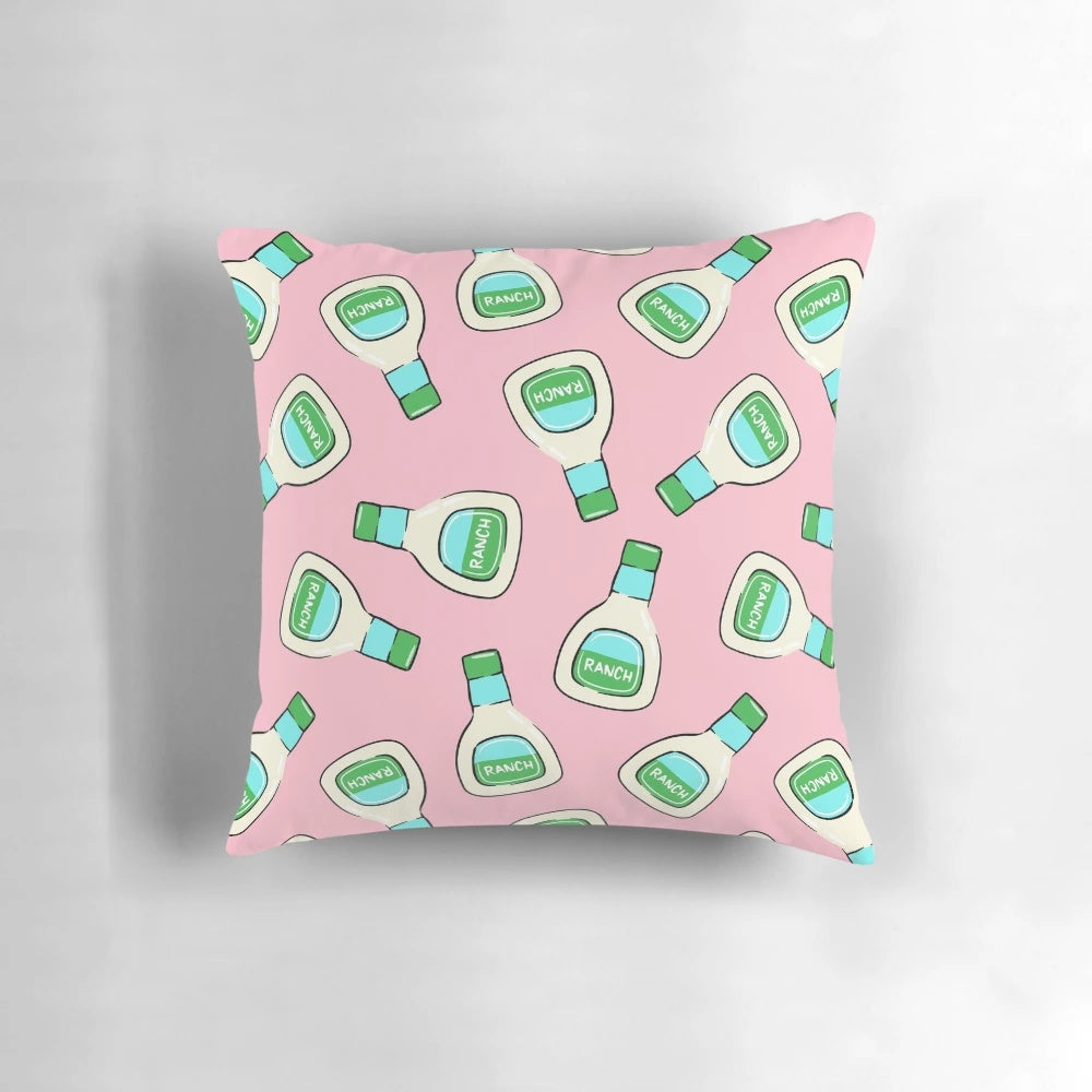 A soft, pink pillow featuring a ranch salad dressing bottle design by Little Arrow Designs.