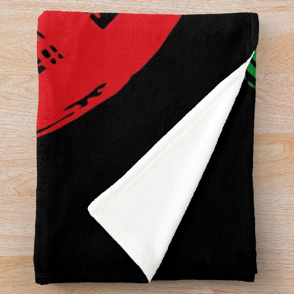 Plush black blanket with peace symbol in rastafarian colors