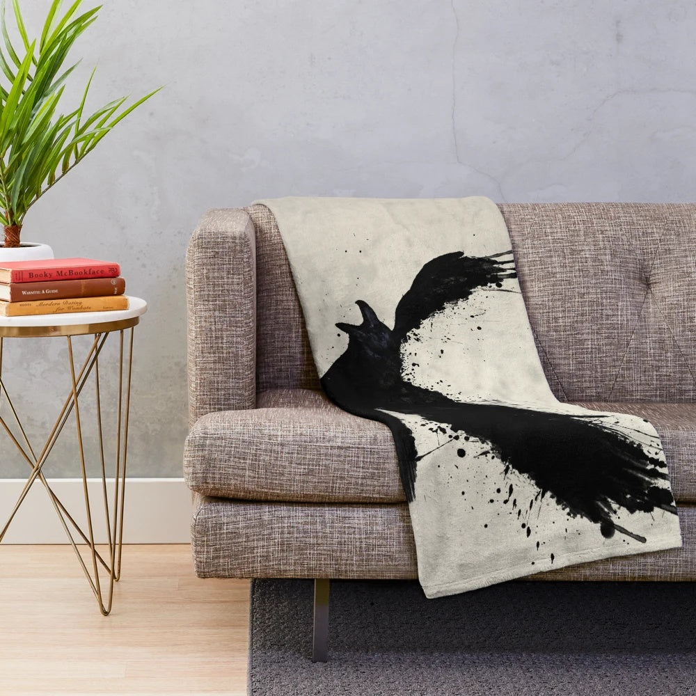 Raven-inspired plush blanket with bird sketch, spatter, and drip design