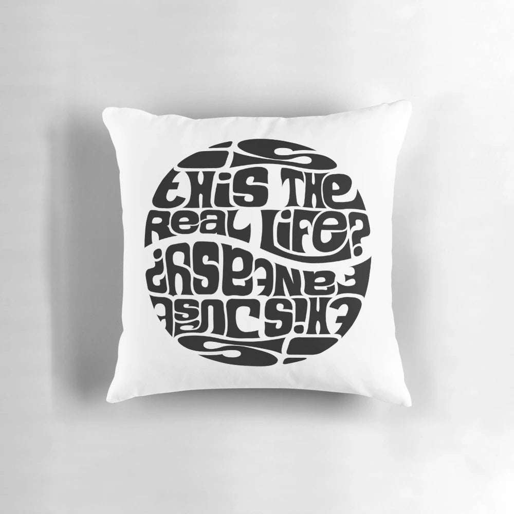 A decorative pillow featuring the lyrics "Is this the real life? Is this just fantasy?" from the Queen song "Bohemian Rhapsody