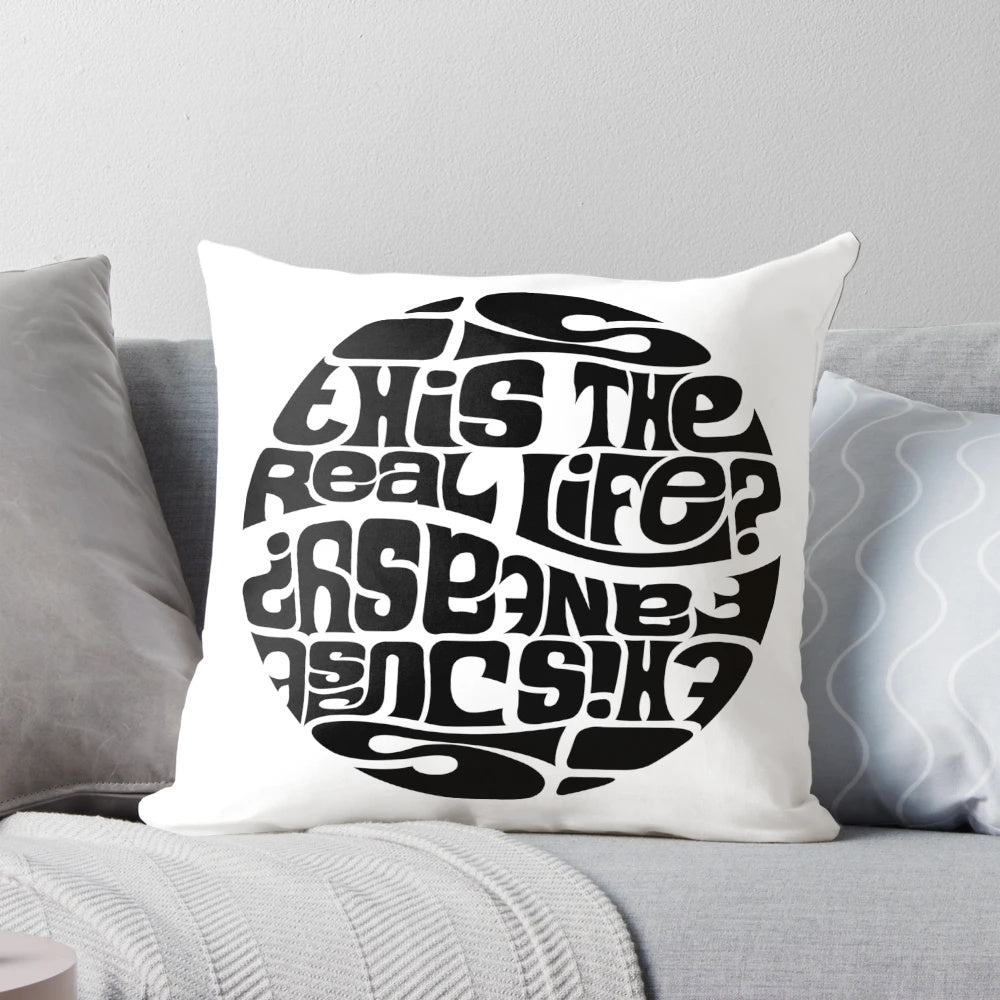 A decorative pillow featuring the lyrics "Is this the real life? Is this just fantasy?" from the Queen song "Bohemian Rhapsody