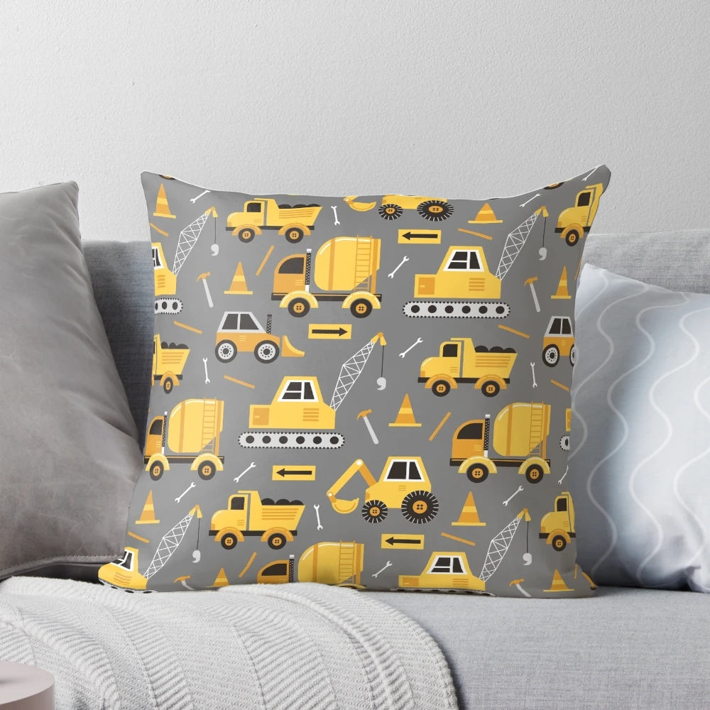 Gray decorative pillow featuring construction trucks and vehicles
