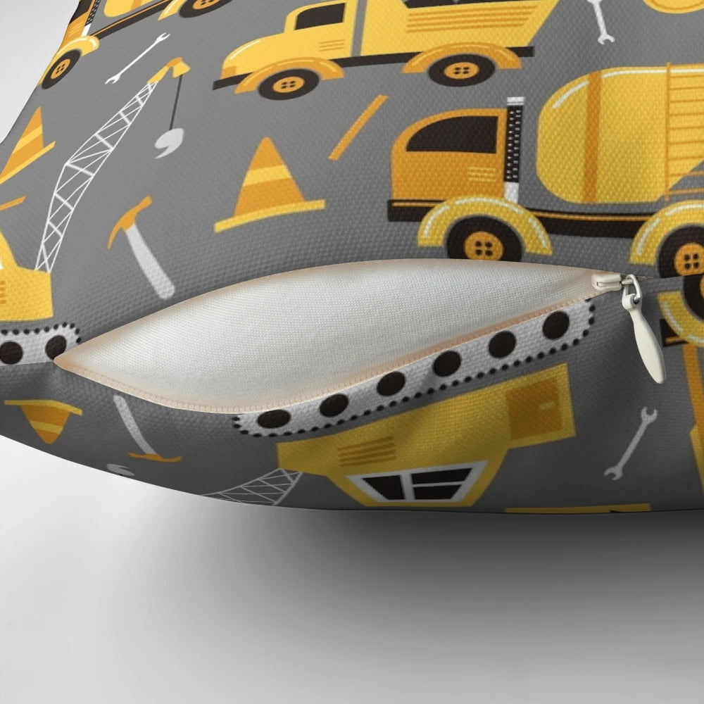 Gray decorative pillow featuring construction trucks and vehicles