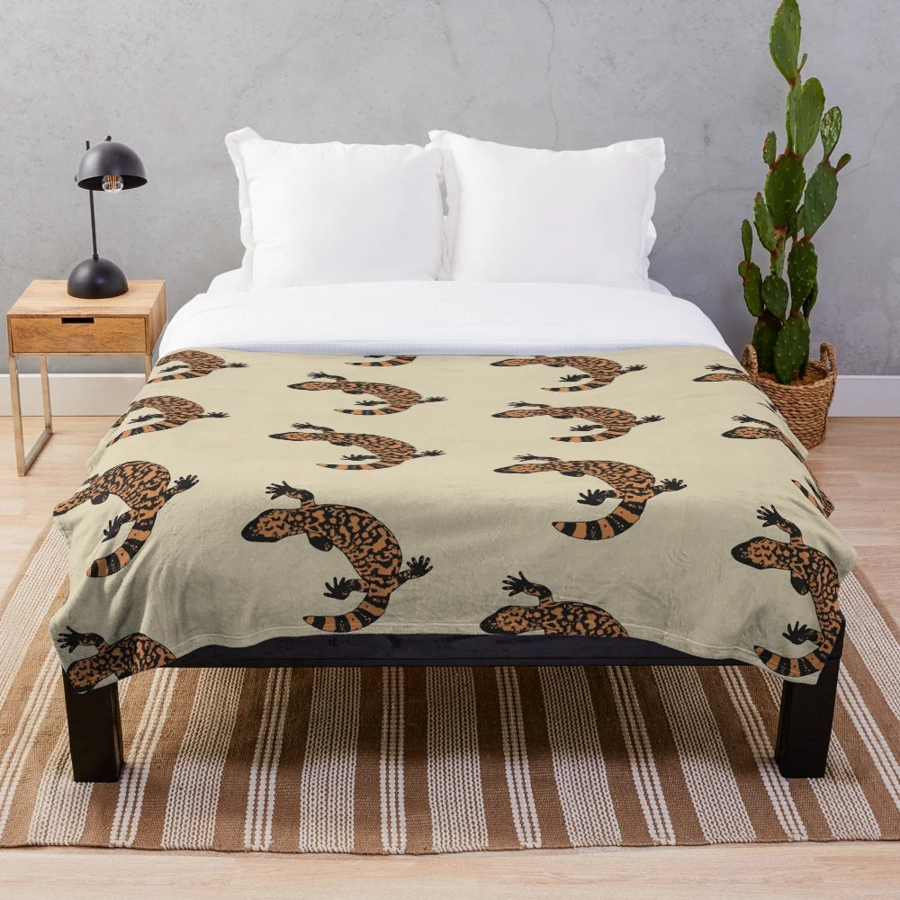 Gila monster plush blanket featuring an orange and black lizard design