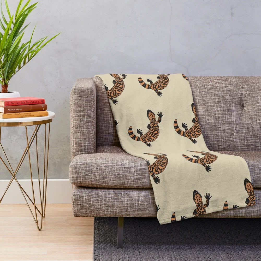 Gila monster plush blanket featuring an orange and black lizard design