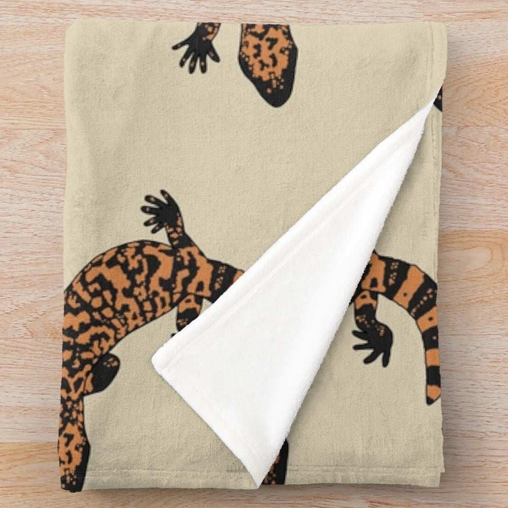 Gila monster plush blanket featuring an orange and black lizard design