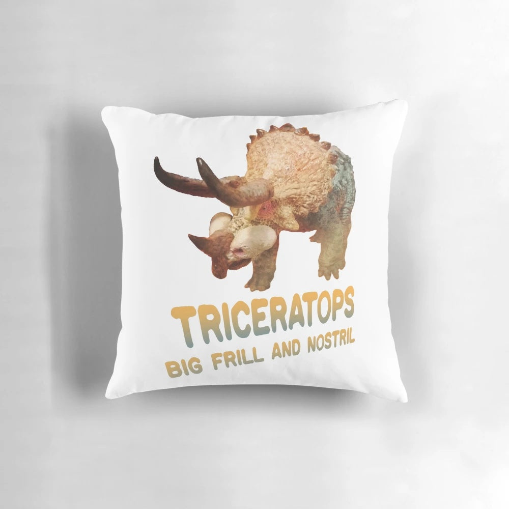 Plush triceratops dinosaur-shaped pillow with textured scales and horns