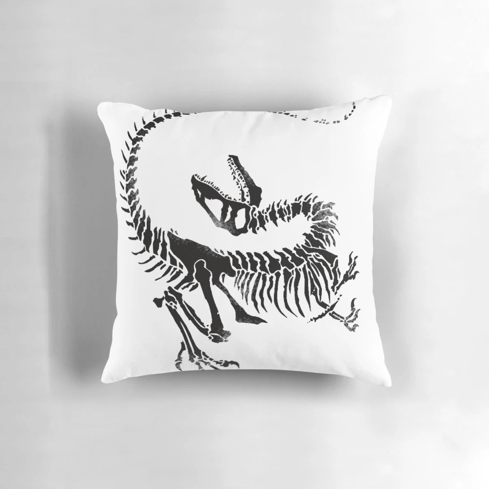 Realistic print of a velociraptor dinosaur skeleton on a decorative throw pillow.