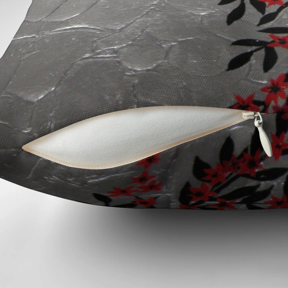 Red, black, and silver cherry blossom tree art design on a decorative accent pillow