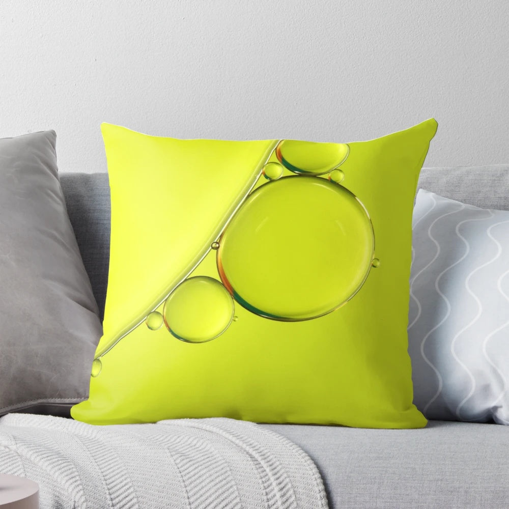 Closeup of a simple, lime-colored pillow with abstract bubbles and a minimalist design