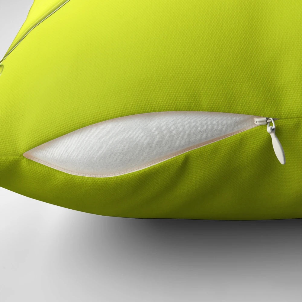 Closeup of a simple, lime-colored pillow with abstract bubbles and a minimalist design