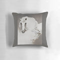 White pillow with a queen and horse design
