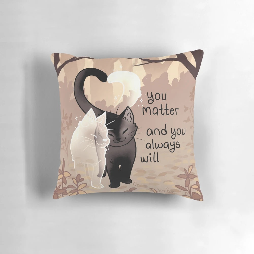 A black cat and ghost cat on a throw pillow with the text "You Matter and You Always Will"