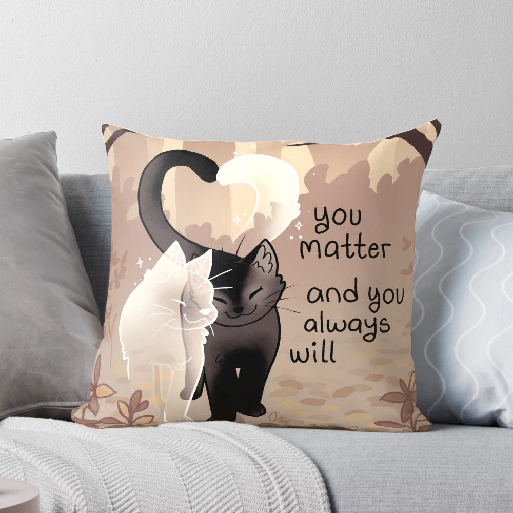 A black cat and ghost cat on a throw pillow with the text "You Matter and You Always Will"