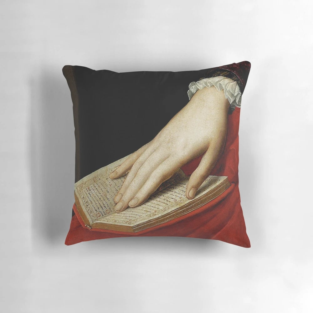 Renaissance old master painting-inspired pillow featuring a cropped image of a hand on a book