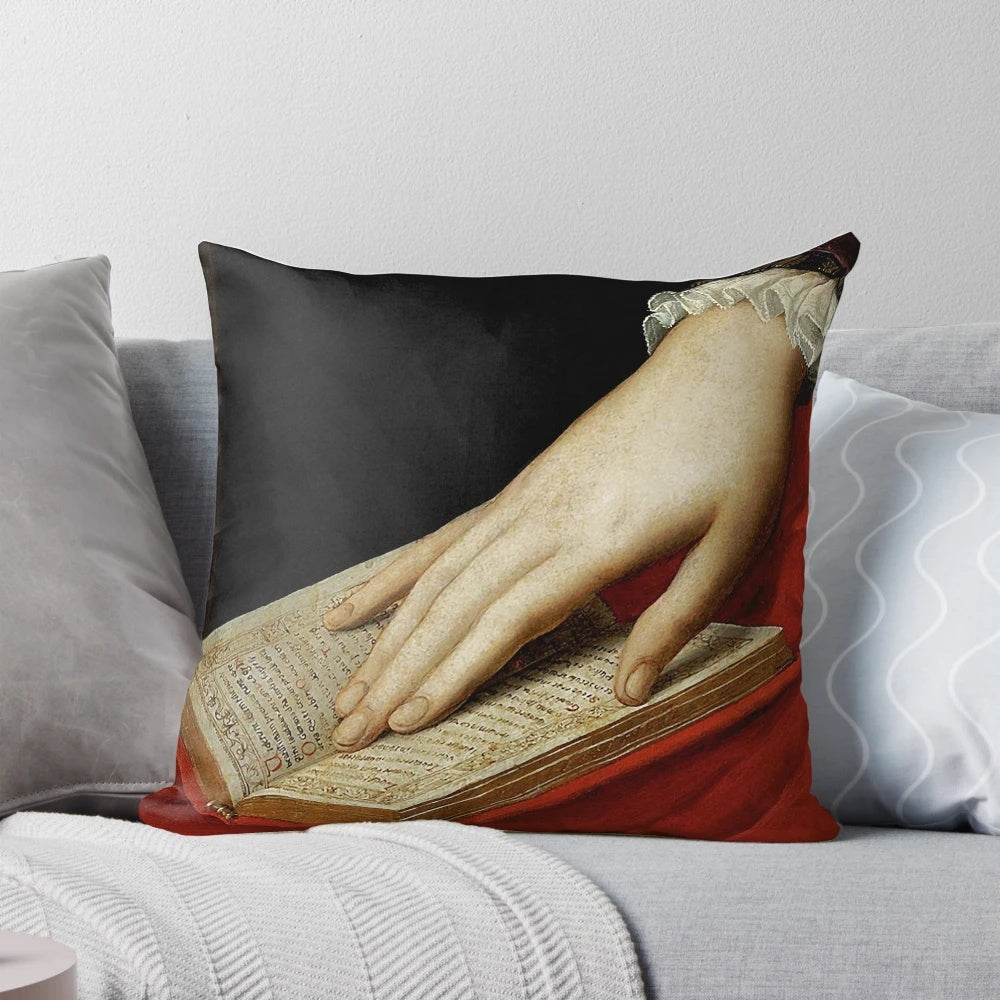 Renaissance old master painting-inspired pillow featuring a cropped image of a hand on a book