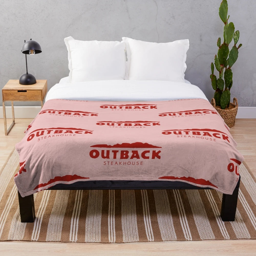 Outback Steakhouse-themed plush blanket with restaurant logo and food imagery
