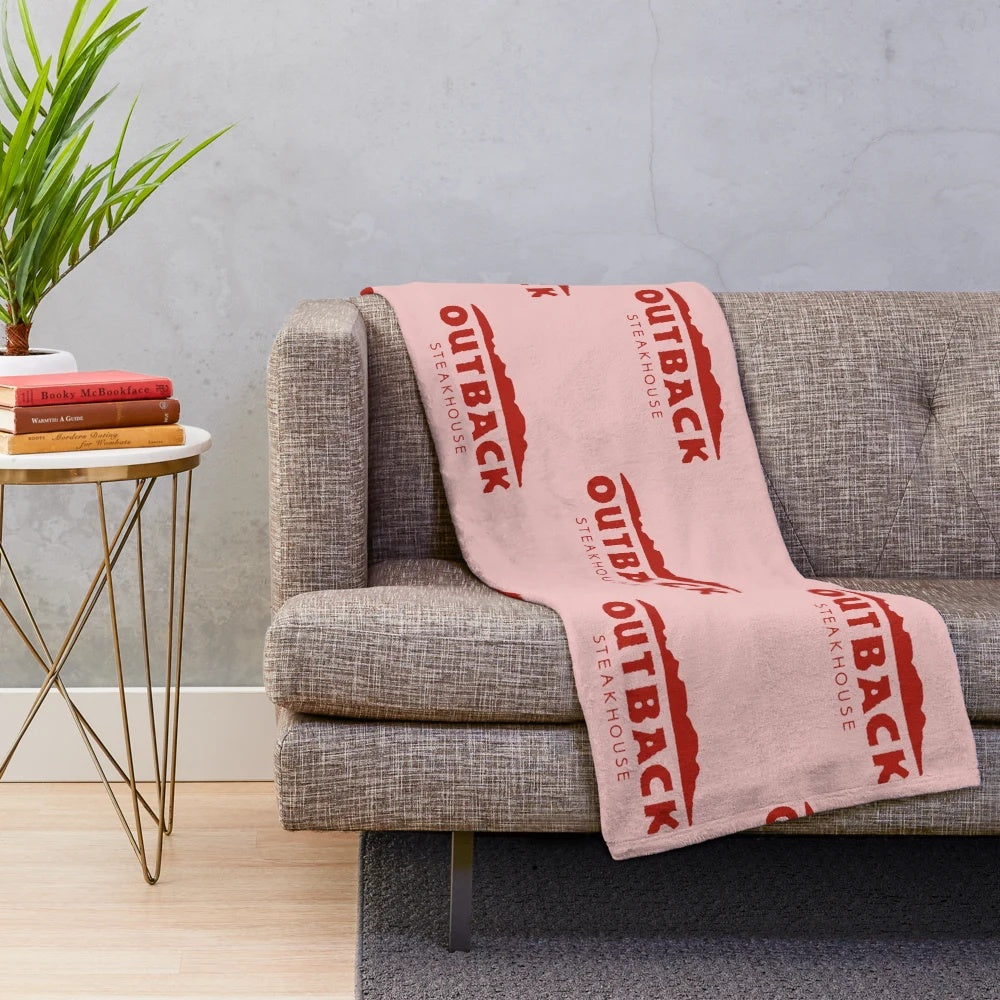 Outback Steakhouse-themed plush blanket with restaurant logo and food imagery