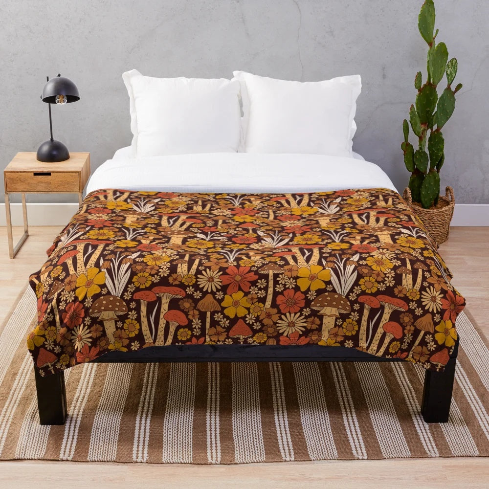 Retro 1970s inspired plush blanket with brown, orange, and yellow mushrooms and flowers