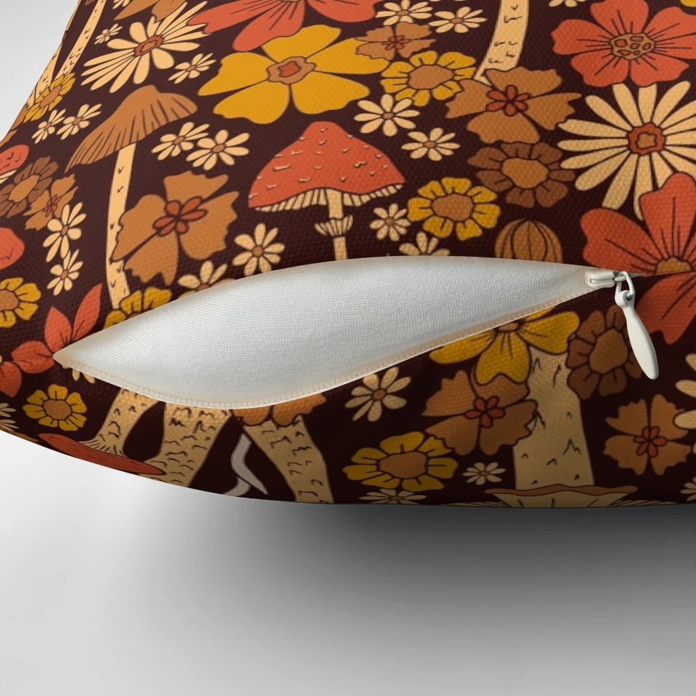 Retro 1970s-style throw pillow featuring mushrooms and flowers in brown, orange, and floral patterns