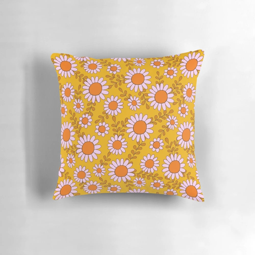 Vibrant pillow featuring a retro 70s daisy flowers botanical pattern in orange and pink tones