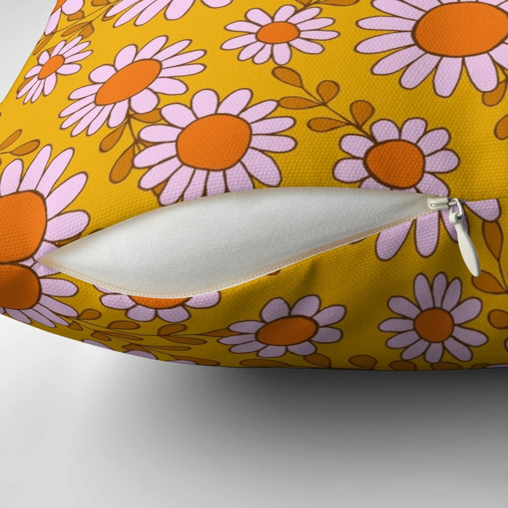 Vibrant pillow featuring a retro 70s daisy flowers botanical pattern in orange and pink tones