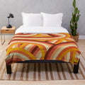 Vintage-inspired plush blanket with vibrant rainbow stripes in a retro 70s style