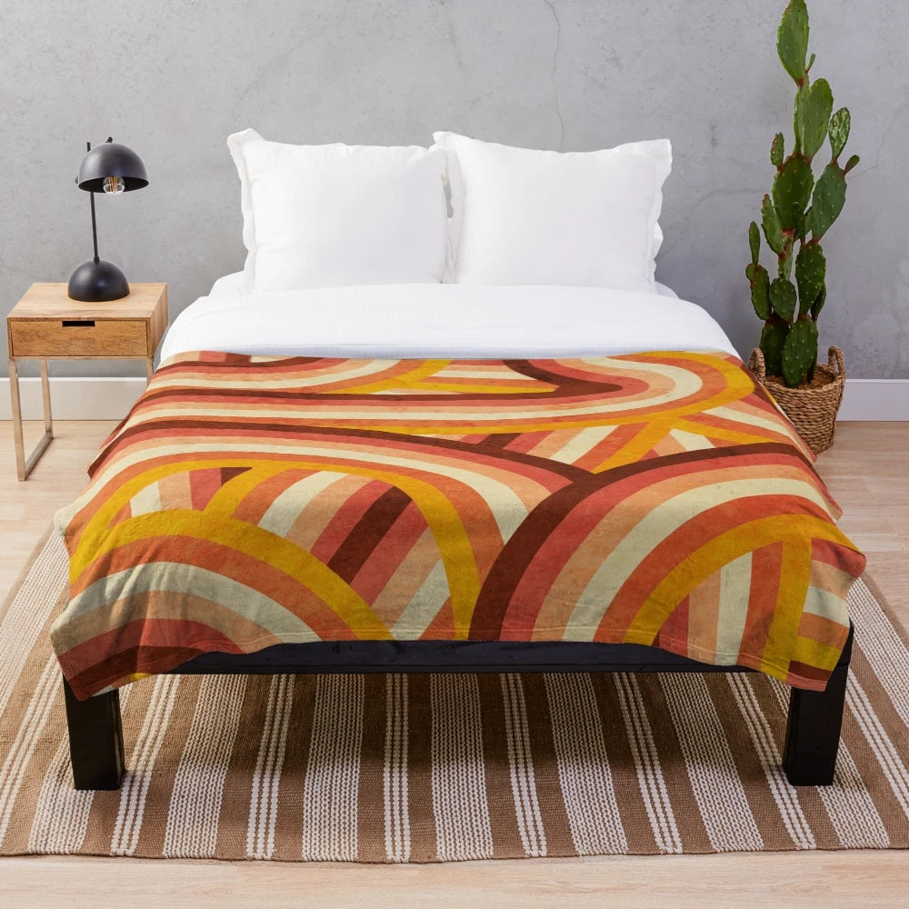 Vintage-inspired plush blanket with vibrant rainbow stripes in a retro 70s style